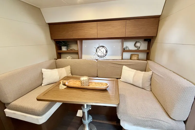 Slide: The Image of Interior of 2017 Beneteau Gran Turismo 46 yacht with cozy seating and wooden table. - 25