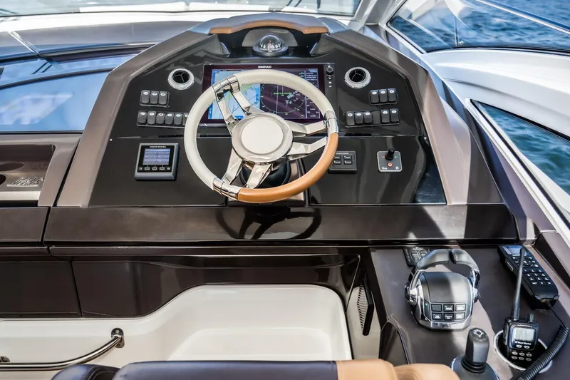 Slide: The Image of Helm of 2017 Beneteau Gran Turismo 46 yacht with modern navigation controls. - 28