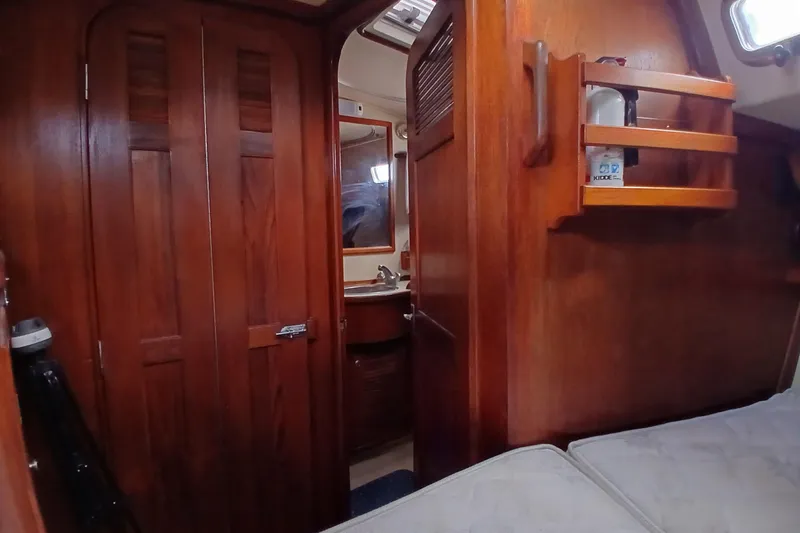 Slide: The Image of Interior of 1995 Island Packet 37 sailboat with wooden cabinetry and compact bathroom. - 23