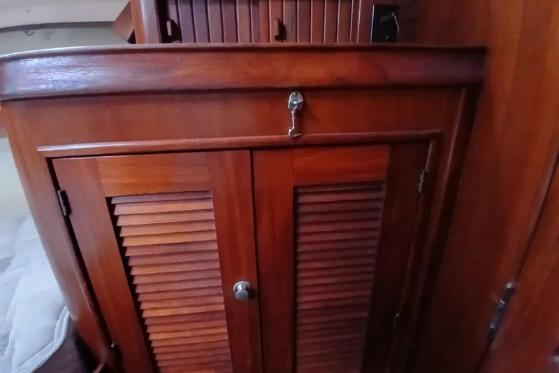 Slide: The Image of Wooden cabinet interior of 1995 Island Packet 37 sailboat. - 24