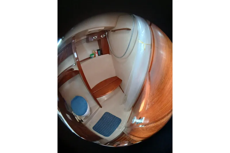 Slide: The Image of Interior of 1995 Island Packet 37 sailboat, featuring wooden finishes and compact design. - 29
