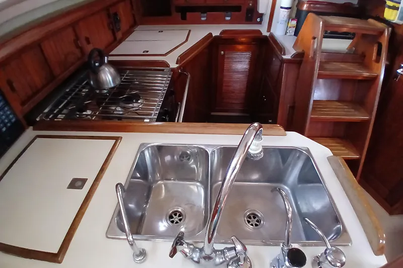 Slide: The Image of Interior of 1995 Island Packet 37 sailboat kitchen with sink and stove. - 33