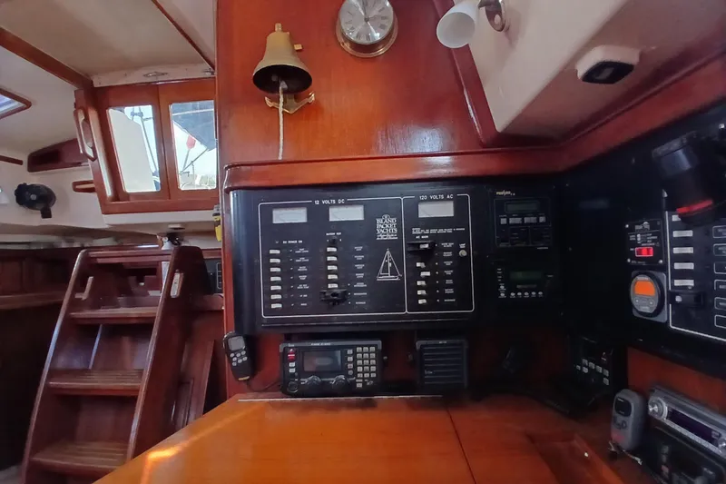 Slide: The Image of Interior view of a 1995 Island Packet 37 sailboat's navigation panel and controls. - 43