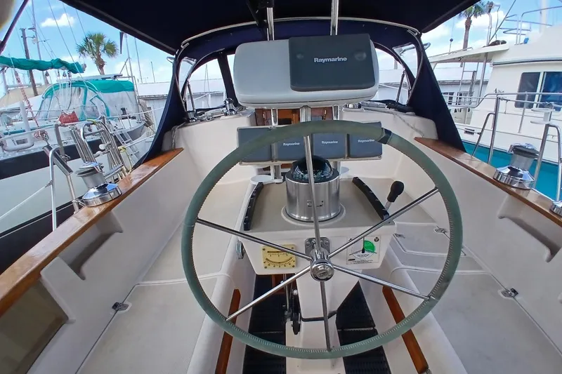 Slide: The Image of Cockpit of a 1995 Island Packet 37 sailboat with steering wheel and navigation equipment. - 47