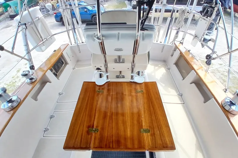 Slide: The Image of Cockpit of a 1995 Island Packet 37 sailboat with wooden table and steering wheel. - 54