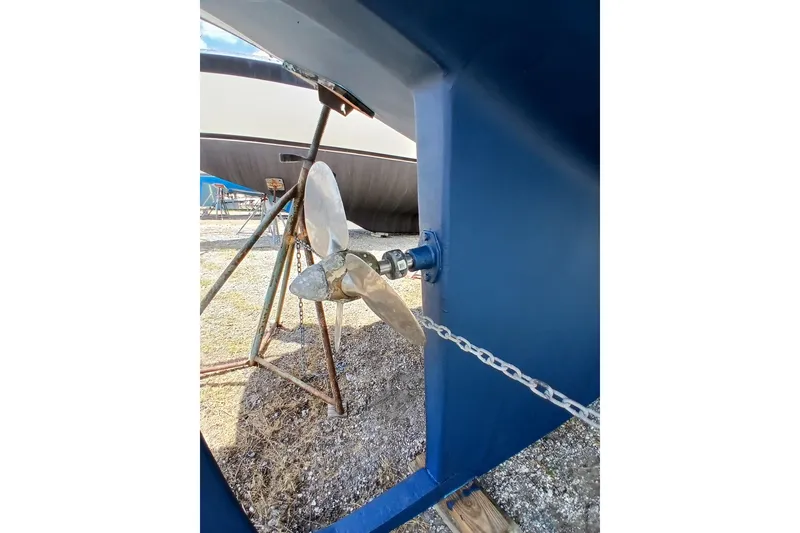 Slide: The Image of Propeller of a 1995 Island Packet 37 sailboat on a stand, with blue hull. - 62