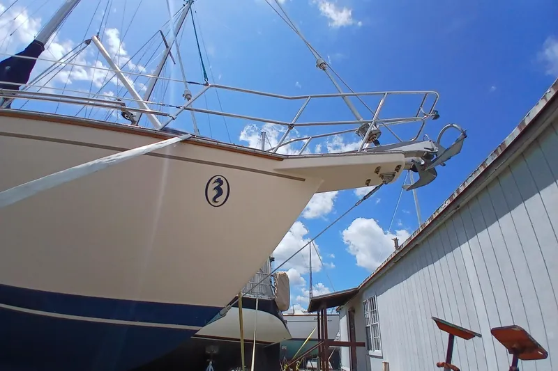Slide: The Image of 1995 Island Packet 37 sailboat docked under a clear blue sky. - 66