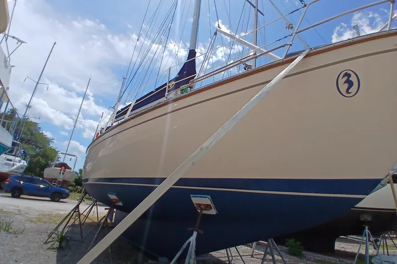 Slide: The Image of 1995 Island Packet 37 sailboat on stands, clear sky background. - 67