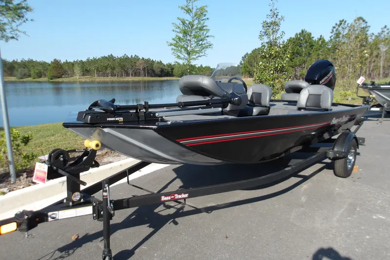 Slide: The Image of 2026 Tracker Bass Tracker Classic XL boat on trailer by a lake. - 2