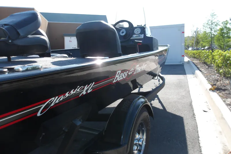 Slide: The Image of 2026 Tracker Bass Tracker Classic XL boat parked outdoors in sunlight. - 4