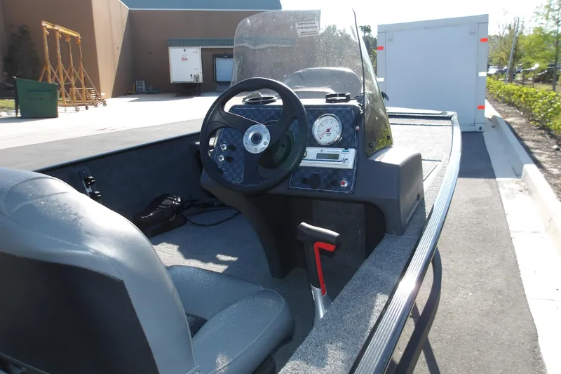 Slide: The Image of 2026 Tracker Bass Tracker Classic XL boat interior with steering wheel and dashboard controls. - 6