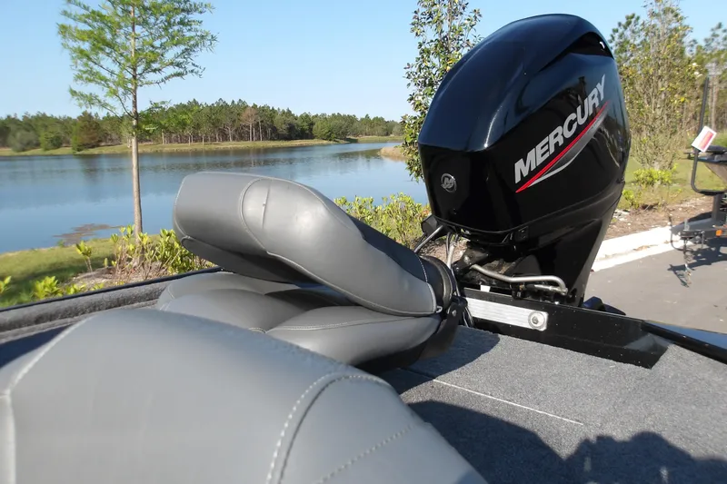 Slide: The Image of 2026 Tracker Bass Tracker Classic XL boat with Mercury engine by a serene lake. - 7