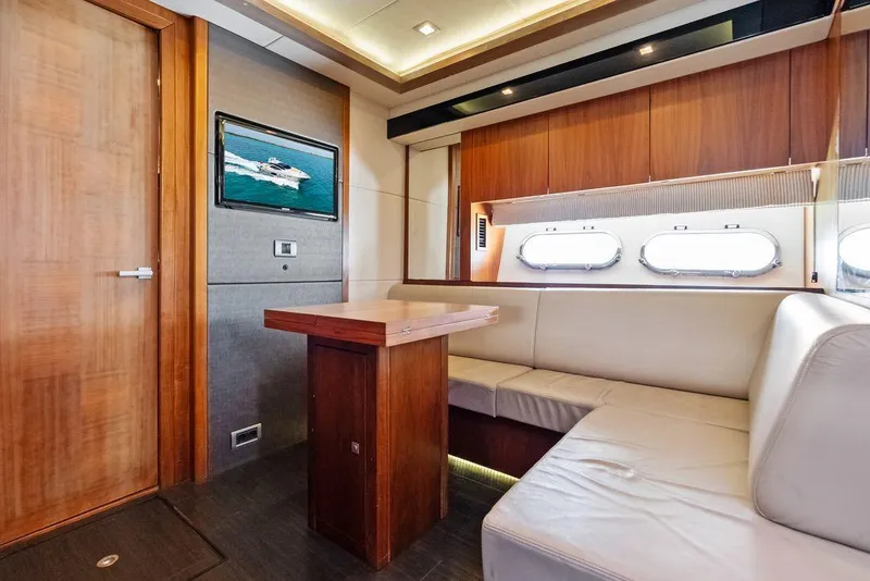 Slide: The Image of Interior of 2011 Sunseeker 64 Predator yacht with elegant wood and leather seating. - 19