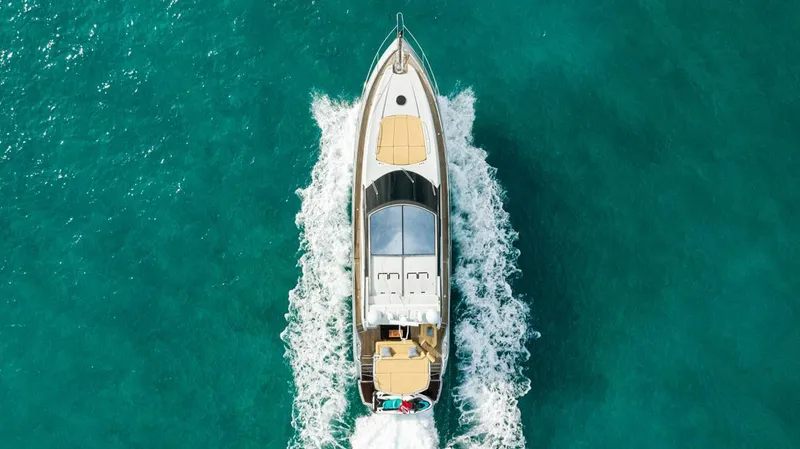 Slide: The Image of Sunseeker 64 Predator 2011 yacht cruising on turquoise water, aerial view. - 5