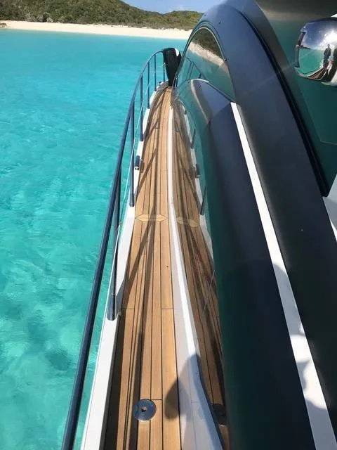 Slide: The Image of 2011 Sunseeker 64 Predator yacht on clear turquoise water near a sandy beach. - 6