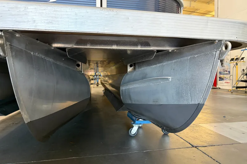 Slide: The Image of 2023 Bennington S22 pontoon boat underside view in a showroom. - 11