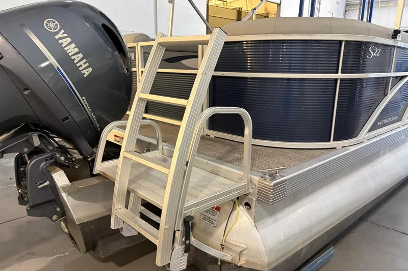 Slide: The Image of 2023 Bennington S22 pontoon boat with Yamaha outboard motor and boarding ladder. - 14