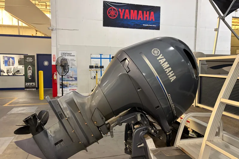 Slide: The Image of 2023 Bennington S22 with Yamaha outboard motor in a showroom setting. - 15