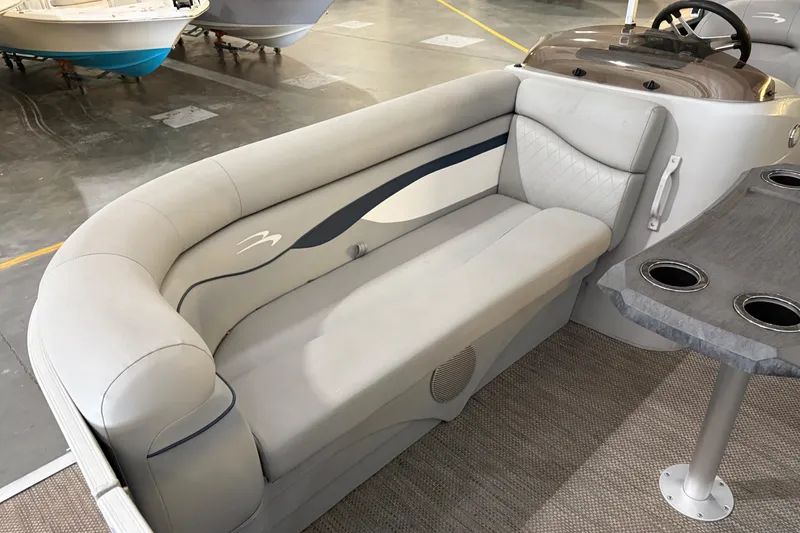 Slide: The Image of 2023 Bennington S22 boat interior with plush seating and cup holders. - 18