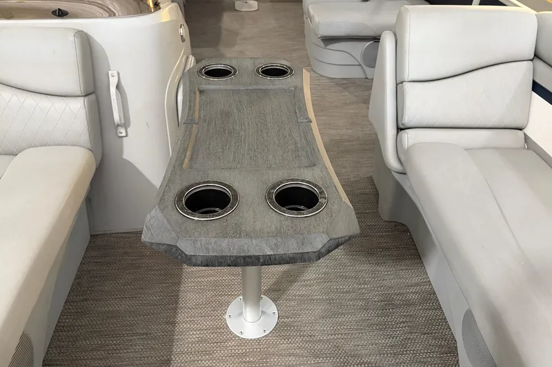 Slide: The Image of Interior of 2023 Bennington S22 boat with seating and table featuring cup holders. - 20