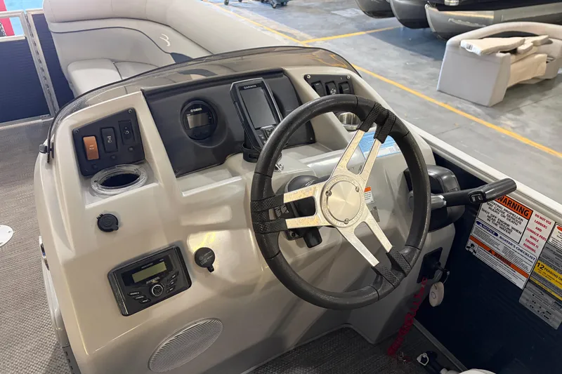 Slide: The Image of Steering console of 2023 Bennington S22 pontoon boat with modern controls and navigation system. - 23