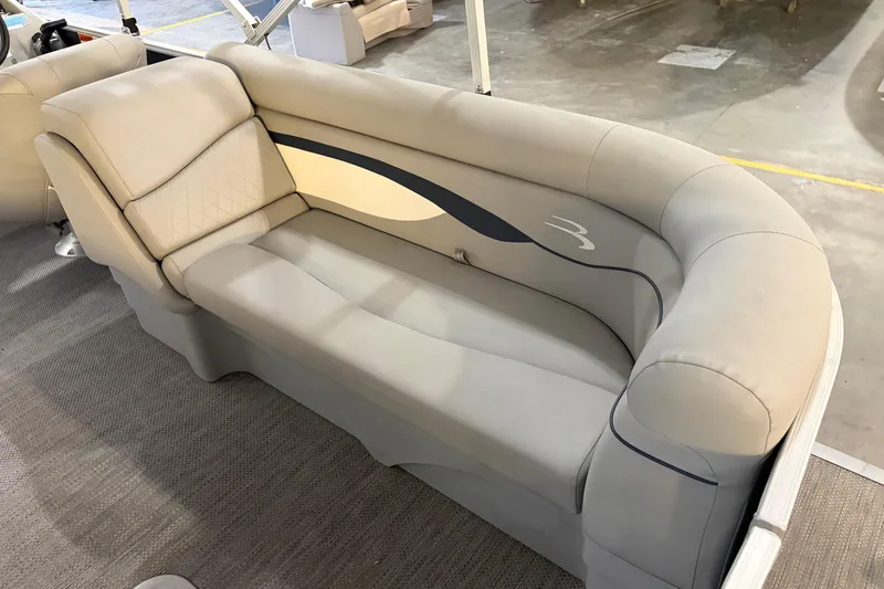 Slide: The Image of 2023 Bennington S22 boat interior with beige cushioned seating. - 26