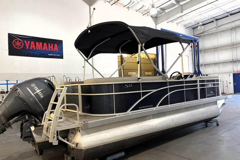 Slide: The Image of 2023 Bennington S22 pontoon boat with Yamaha engine in a showroom. - 3