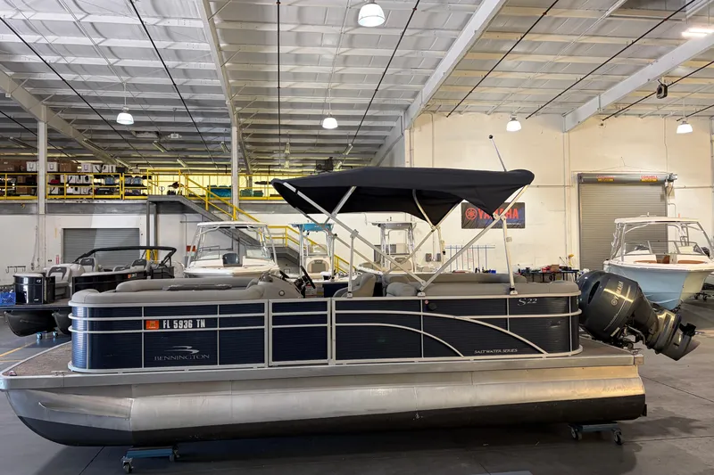 Slide: The Image of 2023 Bennington S22 pontoon boat in a warehouse with Yamaha engine. - 5