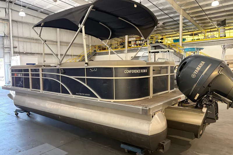 Slide: The Image of 2023 Bennington S22 pontoon boat with Yamaha engine in a warehouse setting. - 6