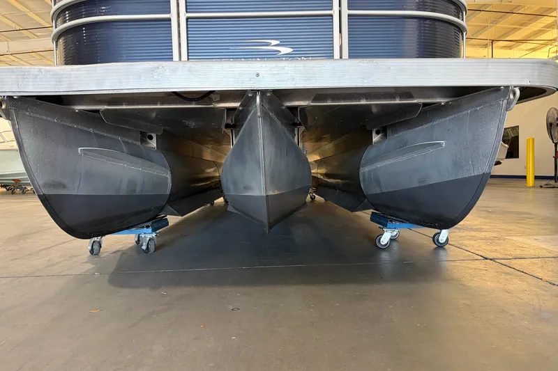 Slide: The Image of 2023 Bennington S22 pontoon boat underside view in a warehouse setting. - 9