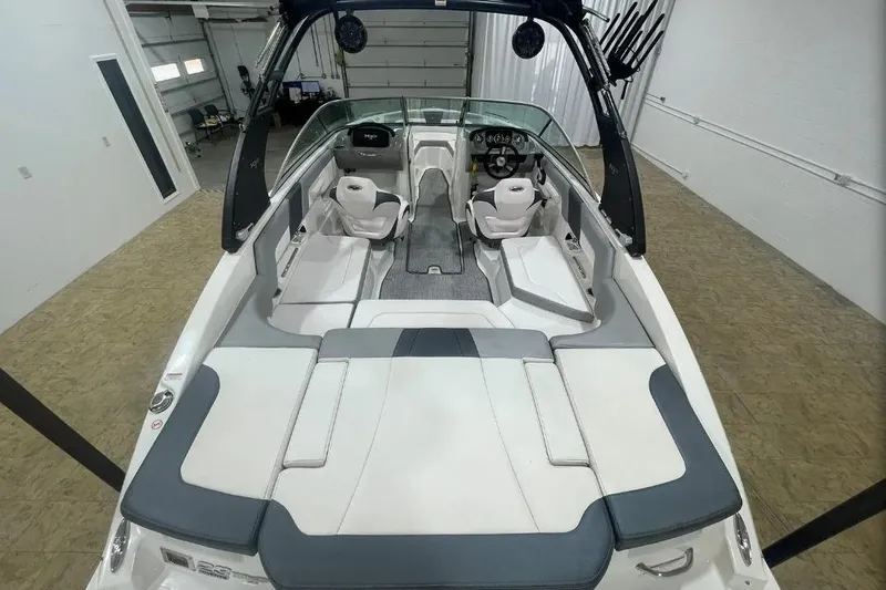 Slide: The Image of 2019 Chaparral 23 H2O Sport boat interior with seating and steering wheel. - 13