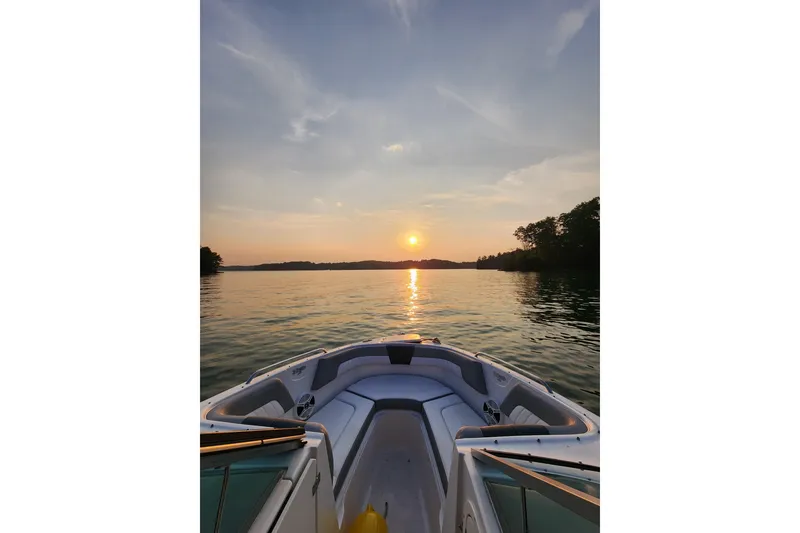 Slide: The Image of 2019 Chaparral 23 H2O Sport boat on serene lake at sunset. - 17