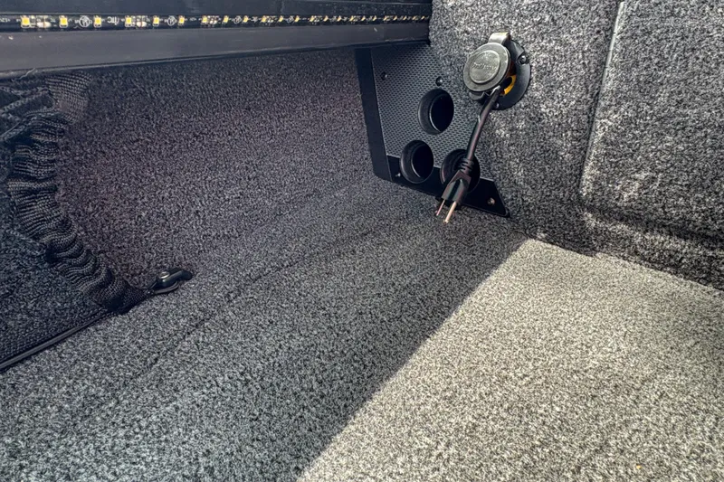 Slide: The Image of Interior view of 2026 Lund 2075 Pro-V Sport boat with carpeted flooring and electrical outlet. - 15