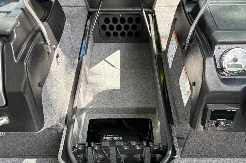 Slide: The Image of Interior view of 2026 Lund 2075 Pro-V Sport boat, featuring storage and control panel. - 17