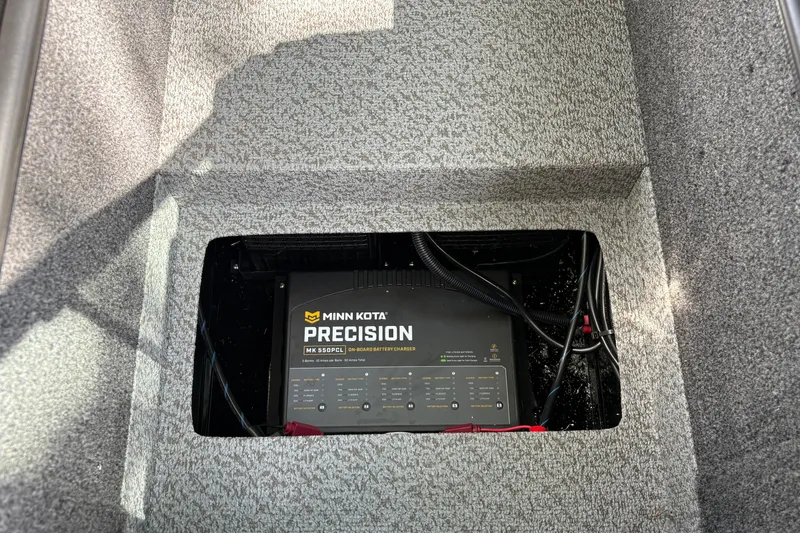 Slide: The Image of Minn Kota Precision charger in 2026 Lund 2075 Pro-V Sport boat compartment. - 18