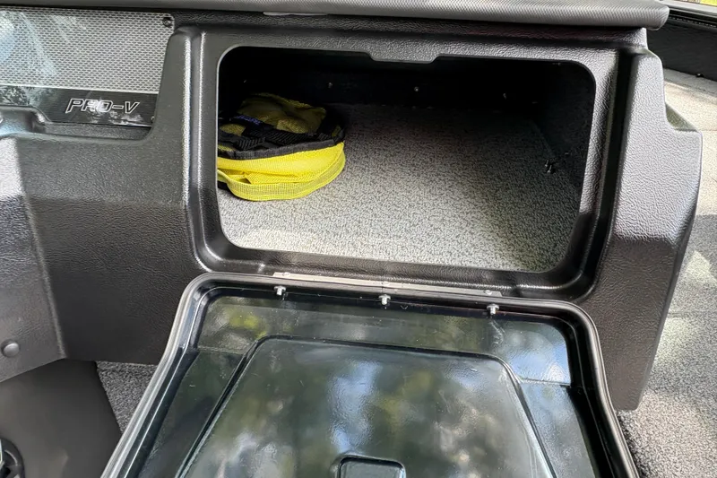 Slide: The Image of Storage compartment in 2026 Lund 2075 Pro-V Sport boat, featuring a yellow bag inside. - 21