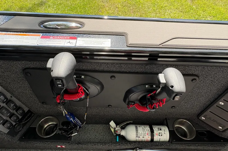 Slide: The Image of Control panel of 2026 Lund 2075 Pro-V Sport boat with throttle levers and safety equipment. - 25