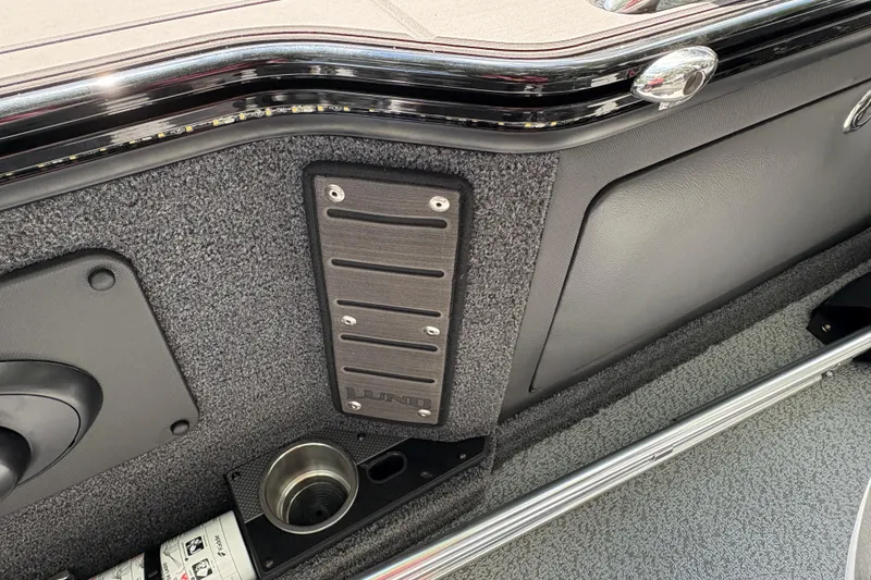 Slide: The Image of Interior detail of 2026 Lund 2075 Pro-V Sport boat, featuring cup holder and textured panel. - 26