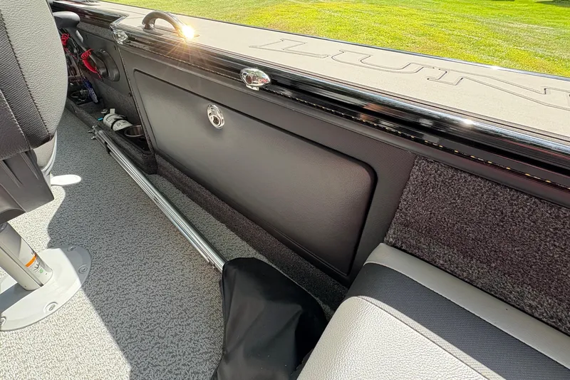 Slide: The Image of Interior view of 2026 Lund 2075 Pro-V Sport boat, showcasing storage compartment and seating. - 27