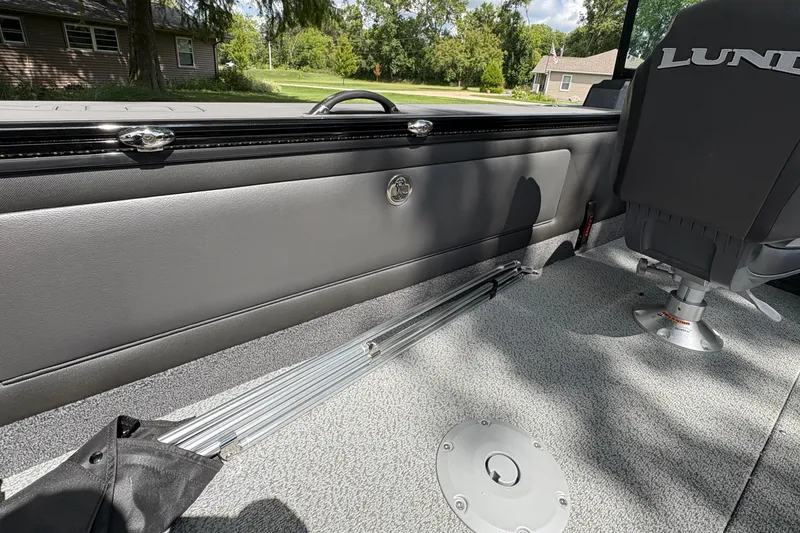 Slide: The Image of Interior of 2026 Lund 2075 Pro-V Sport boat, featuring seating and storage compartments. - 30