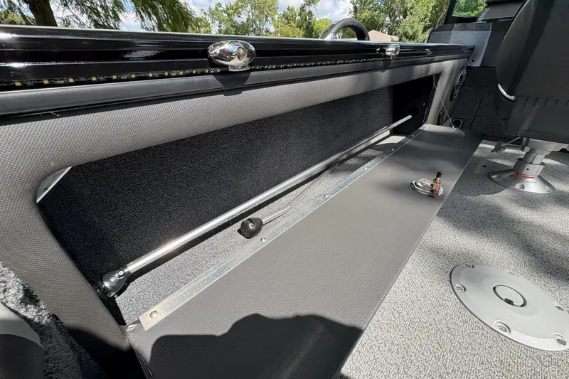 Slide: The Image of Interior view of 2026 Lund 2075 Pro-V Sport boat, showcasing storage compartment and seating. - 31