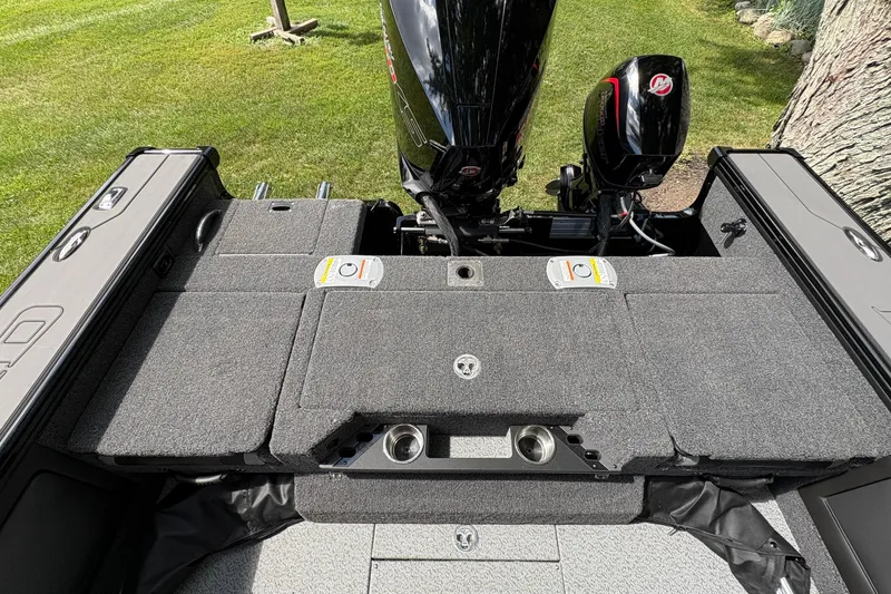 Slide: The Image of 2026 Lund 2075 Pro-V Sport boat deck with motor, featuring spacious storage and seating. - 35