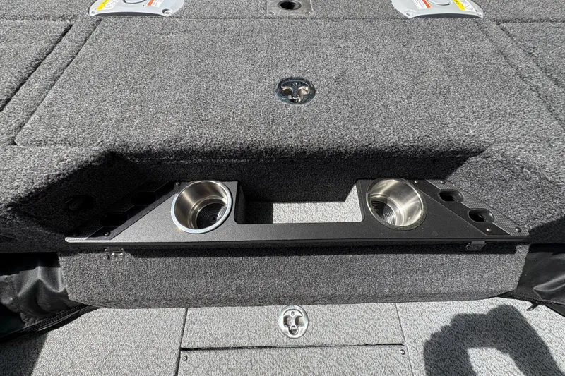 Slide: The Image of 2026 Lund 2075 Pro-V Sport boat interior with cup holders and carpeted flooring. - 36