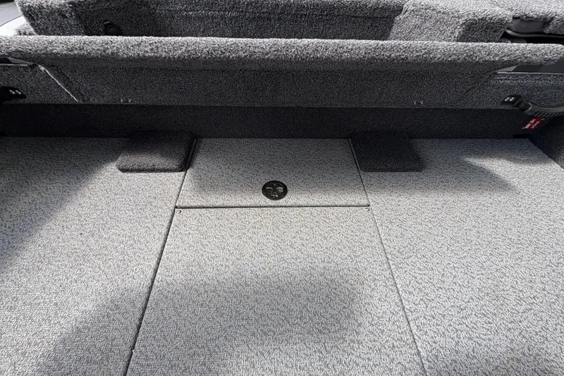 Slide: The Image of Interior view of 2026 Lund 2075 Pro-V Sport boat, featuring carpeted flooring and storage compartment. - 42