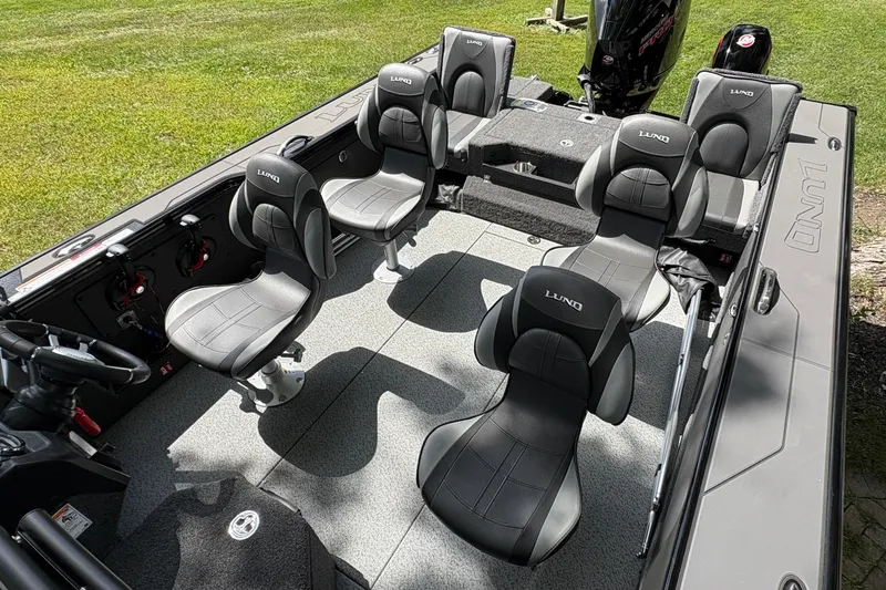 Slide: The Image of 2026 Lund 2075 Pro-V Sport boat interior with five cushioned seats and steering wheel. - 46