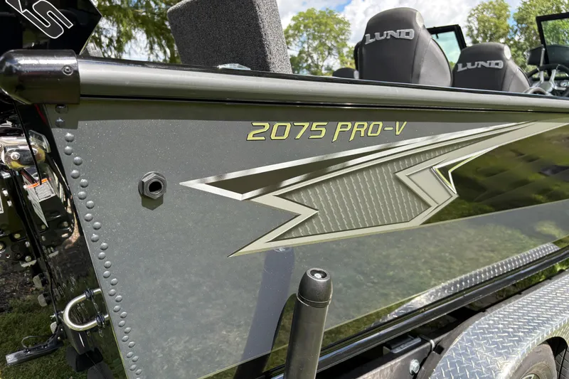 Slide: The Image of 2026 Lund 2075 Pro-V Sport boat with sleek design and logo detail. - 49