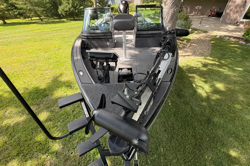 Slide: The Image of 2026 Lund 2075 Pro-V Sport boat on grass, featuring advanced Garmin equipment. - 6