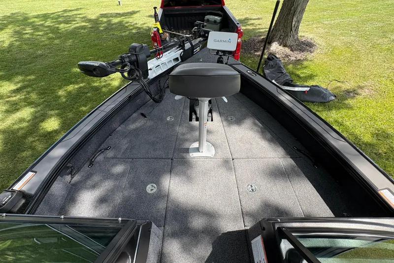 Slide: The Image of 2026 Lund 2075 Pro-V Sport boat interior with Garmin equipment, parked on grass. - 7