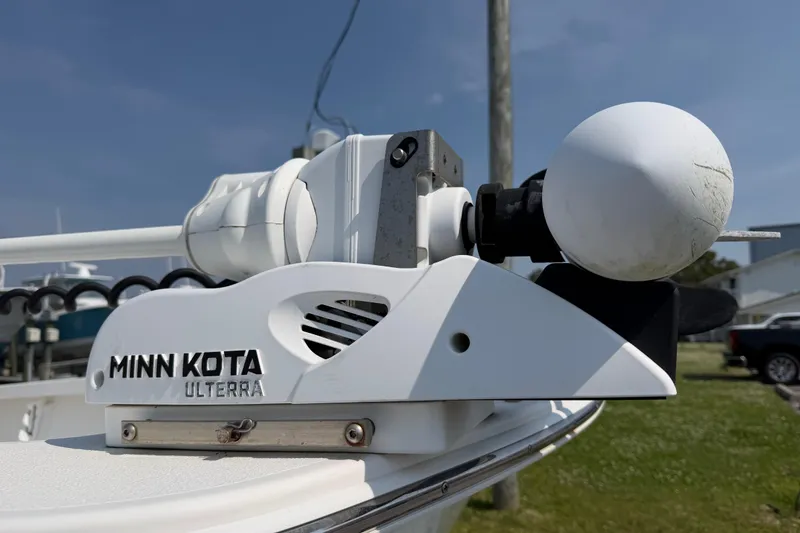 Slide: The Image of Minn Kota Ulterra motor on 2021 Intruder 23 boat, sunny outdoor setting. - 10