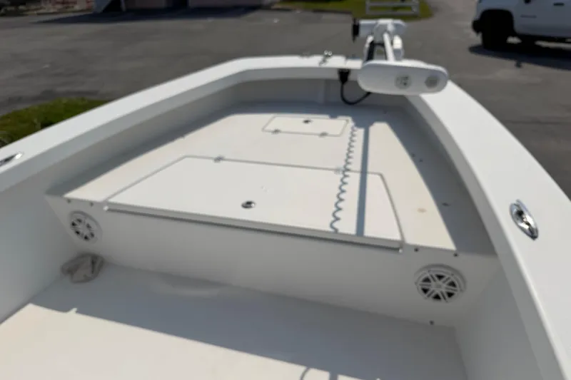 Slide: The Image of 2021 Intruder 23 boat deck with storage compartments and speakers. - 12